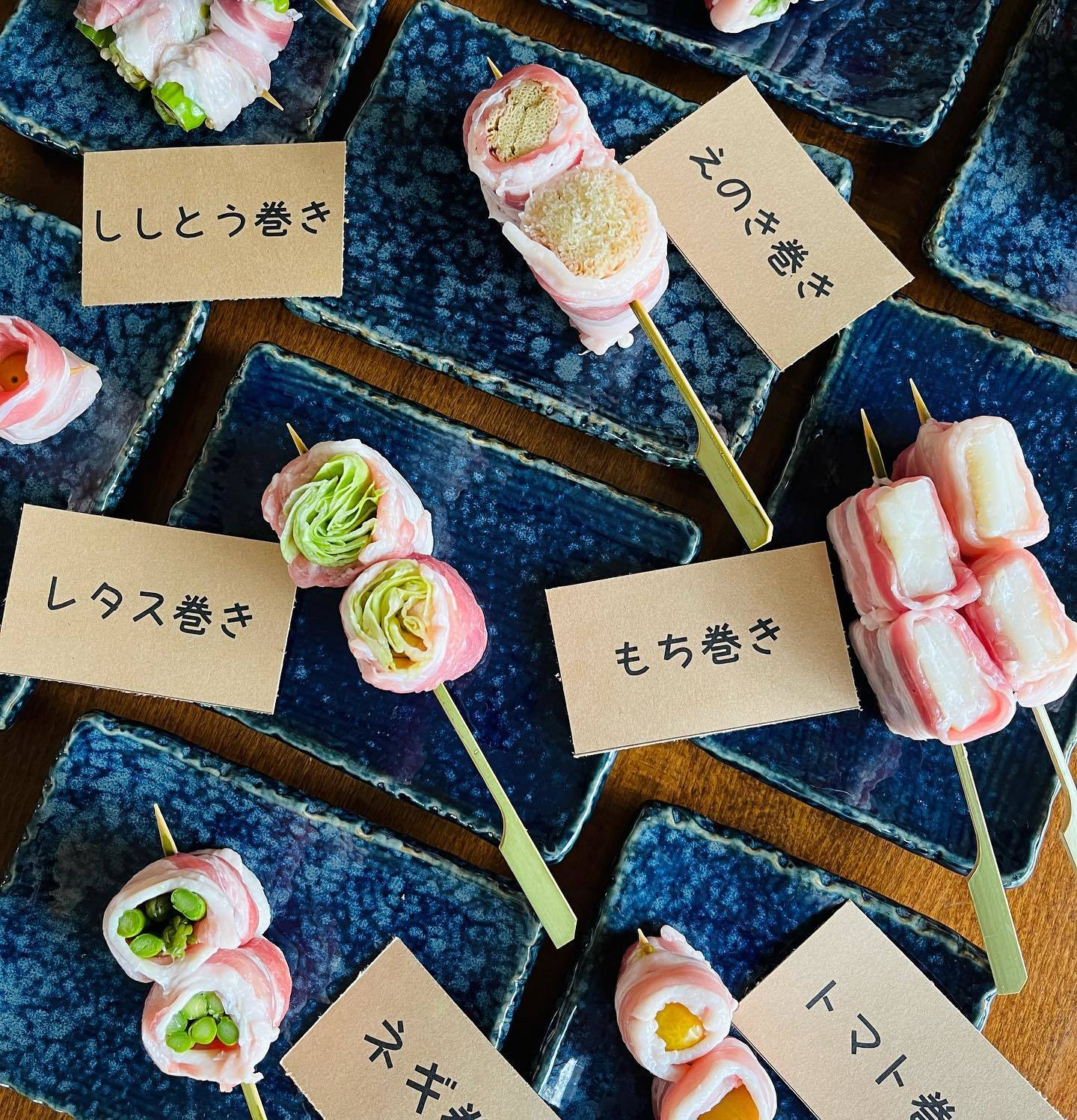 japanese skewered dishes on blue plates